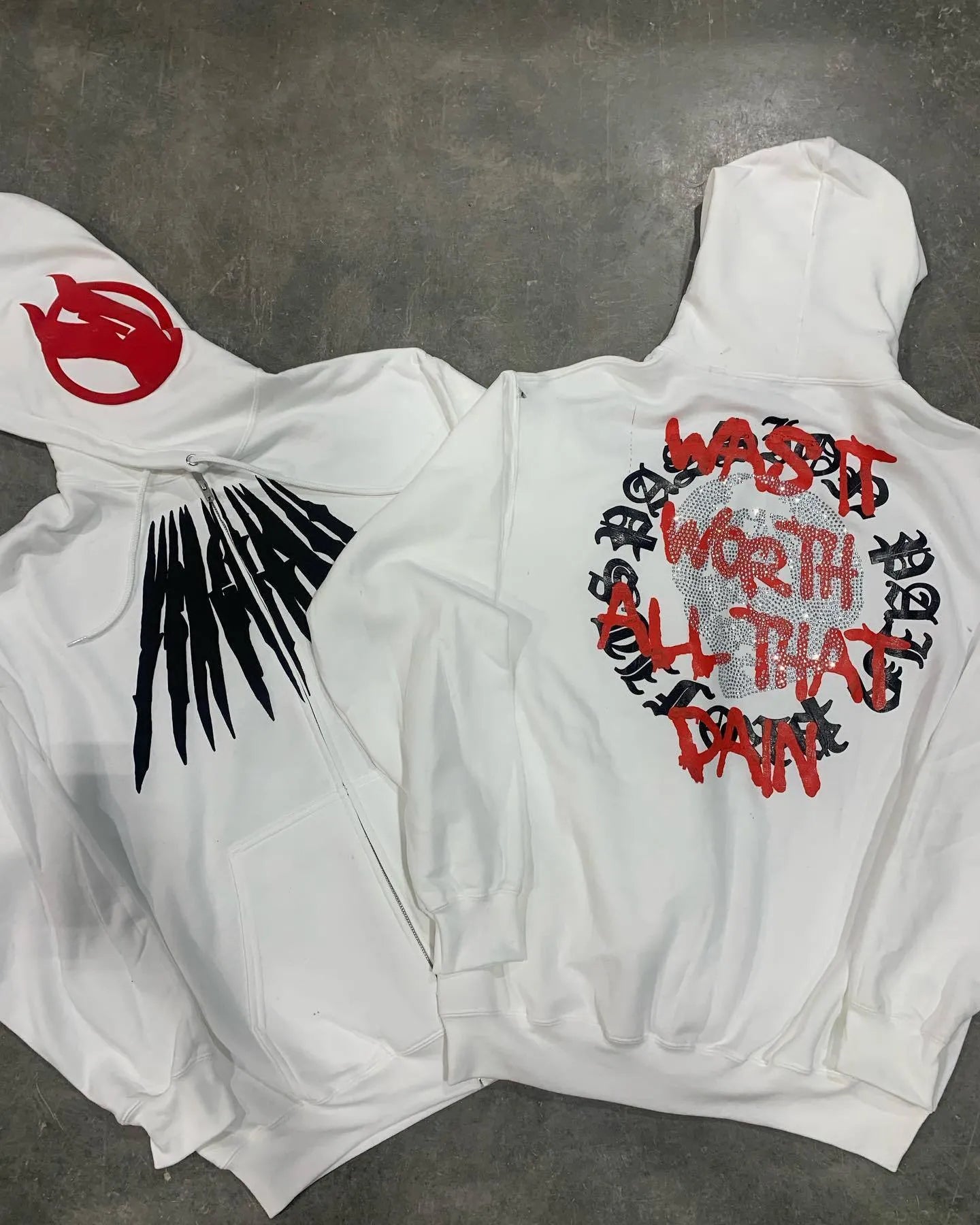 Black loose hooded sweatshirt with printed skull pattern and rhinestone details, cardigan style