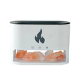 Square white flame effect humidifier and aromatherapy diffuser with coloured 3D light on a desk.