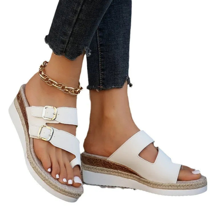 White patent leather women's wedge sandals with finger-fit woven design and peep toe.