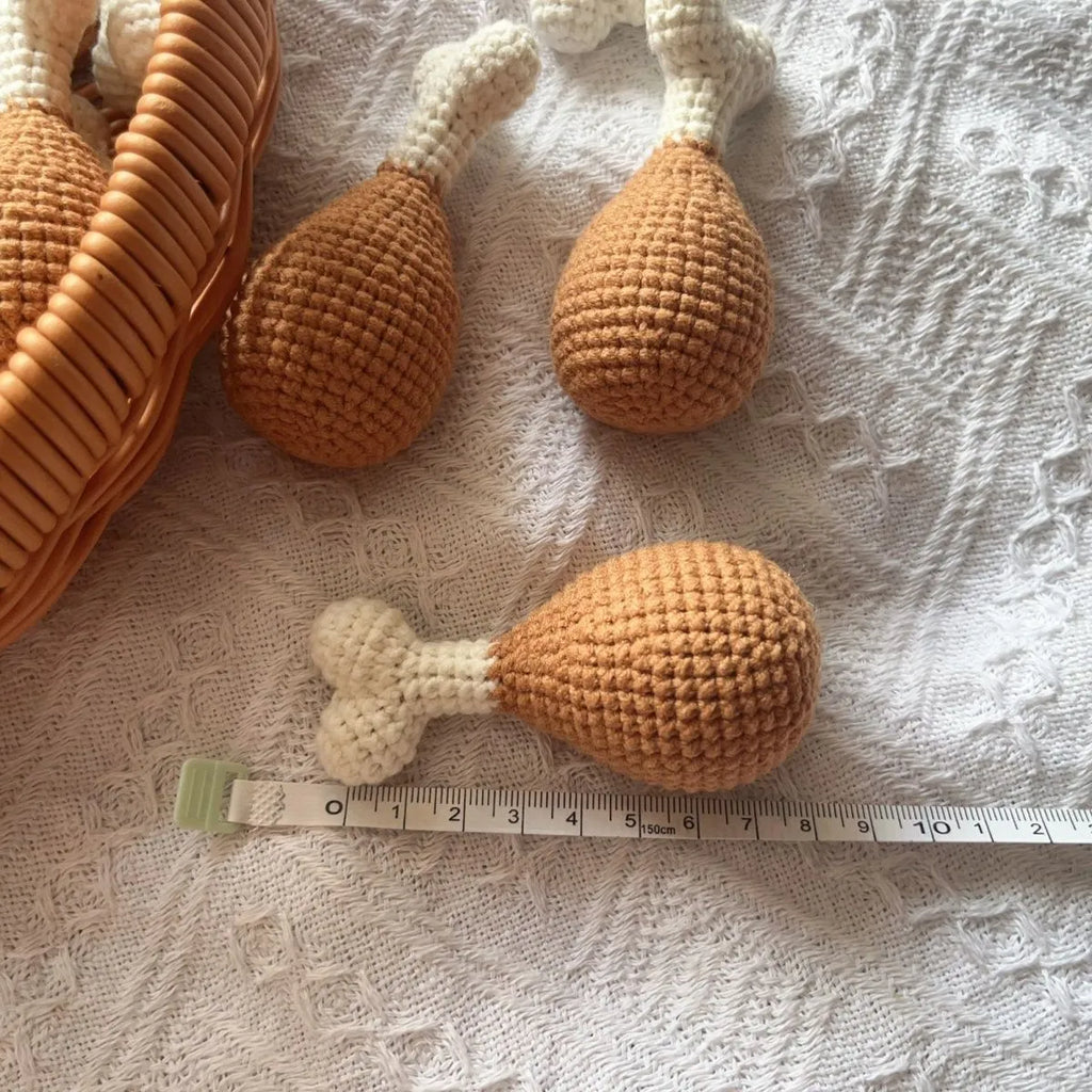 Hand-crocheted beige chicken leg keychain made from soft plush yarn on a metal ring.