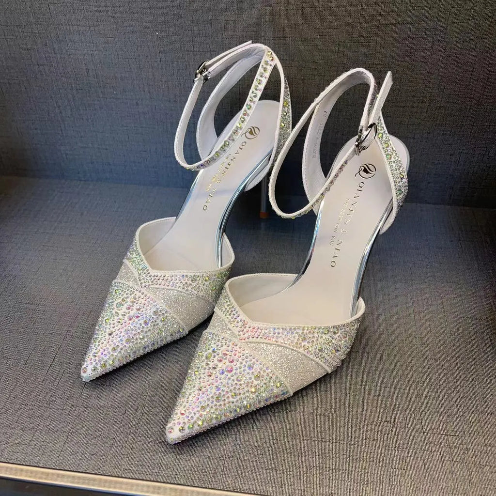Women's hollow high heels with stiletto heel, pointed toe, and red sole in silver and black colours