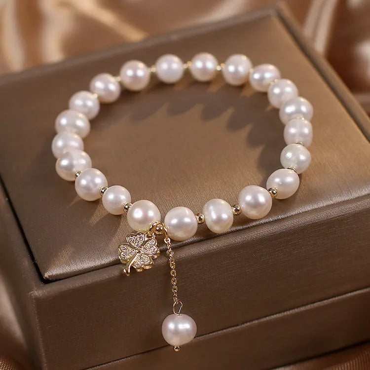White freshwater pearl bracelet with four-leaf clover charm, alloy material, and sequin detail for women