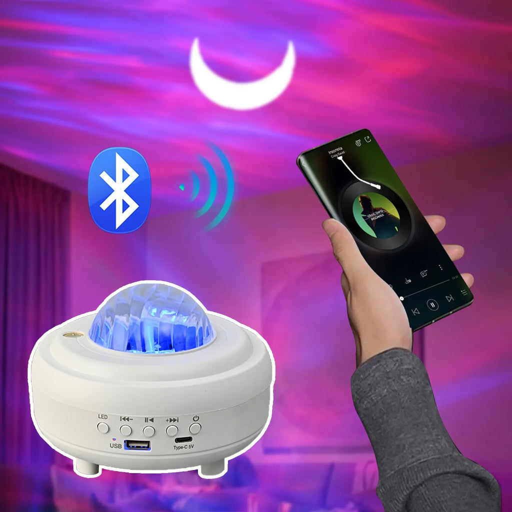 White Galaxy Star Projector on bedside table projecting blue star patterns on wall