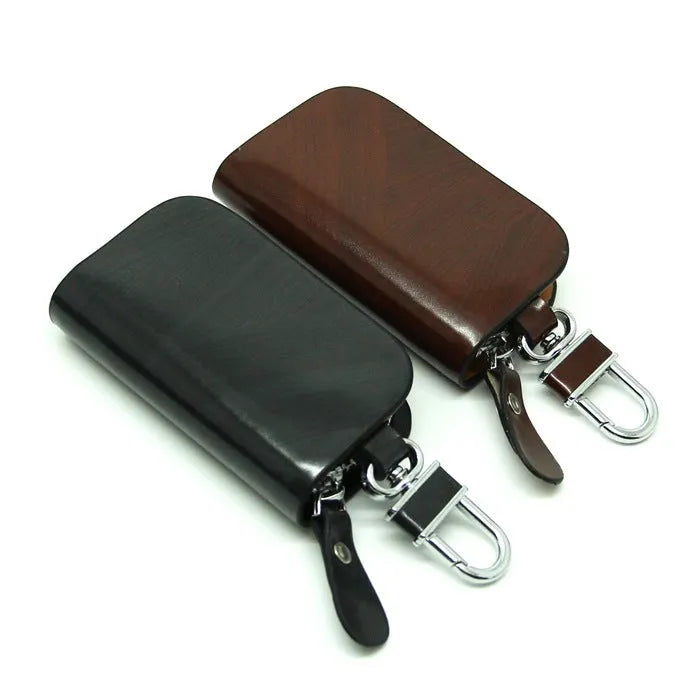 Black or brown genuine leather car key case with zipper, showing soft cowhide texture and internal size of 9.5cm by 4.5cm