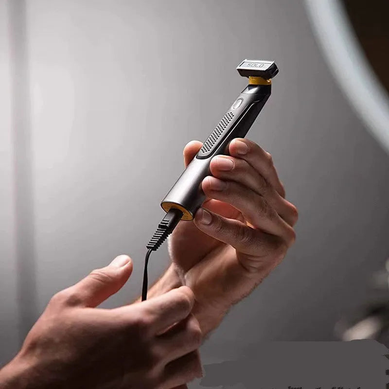 Black wireless rechargeable precision shaver with stainless steel blades, measuring 15cm long with ergonomic handle