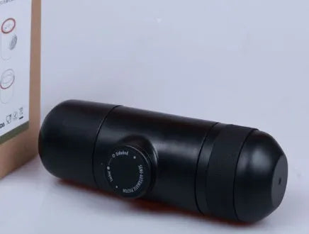 Black portable manual coffee machine showing compact size for travel