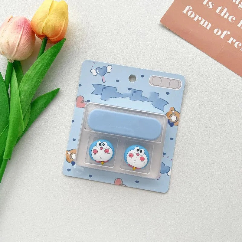 Cartoon-style magnetic plastic cable fixer clip in various colours on a metallic desk surface.