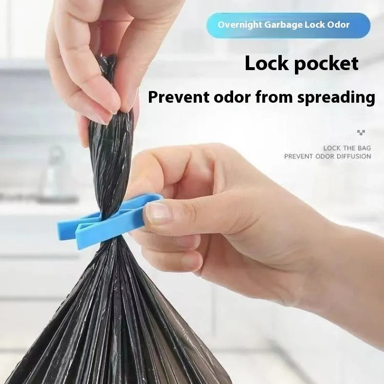 Black plastic non-slip clip for holding bin bags on the side of a trash can.