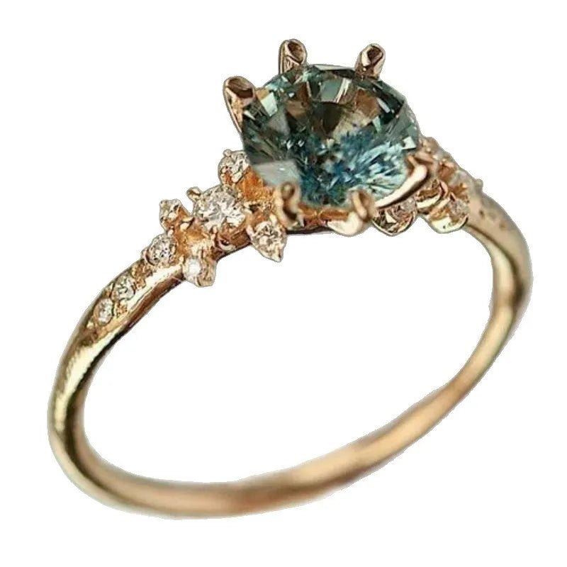 Geometric gold plated ring with chamfered square pattern and zircon stones in claw setting