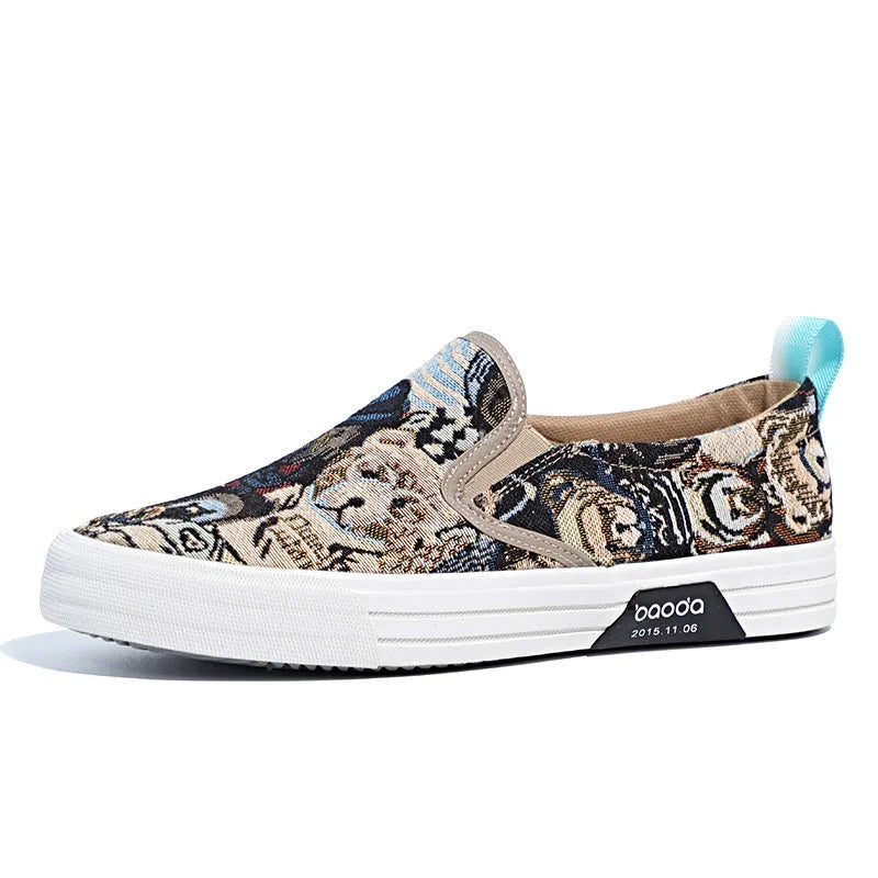 A pair of khaki-coloured canvas slip-on sneakers with a low-top profile, round toe, and vulcanised rubber sole on a plain background.