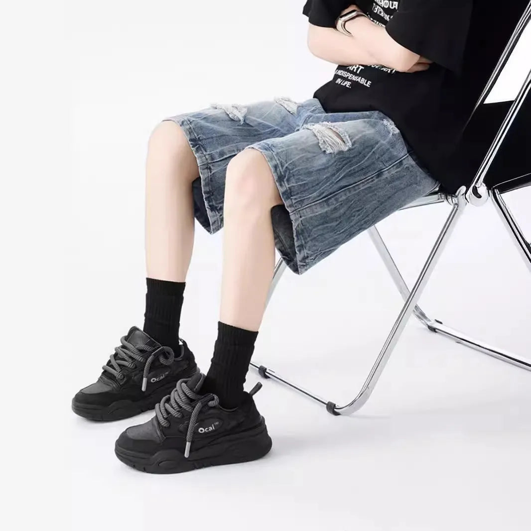 Retro loose-fit ripped denim shorts in washed black or blue with distressed detailing