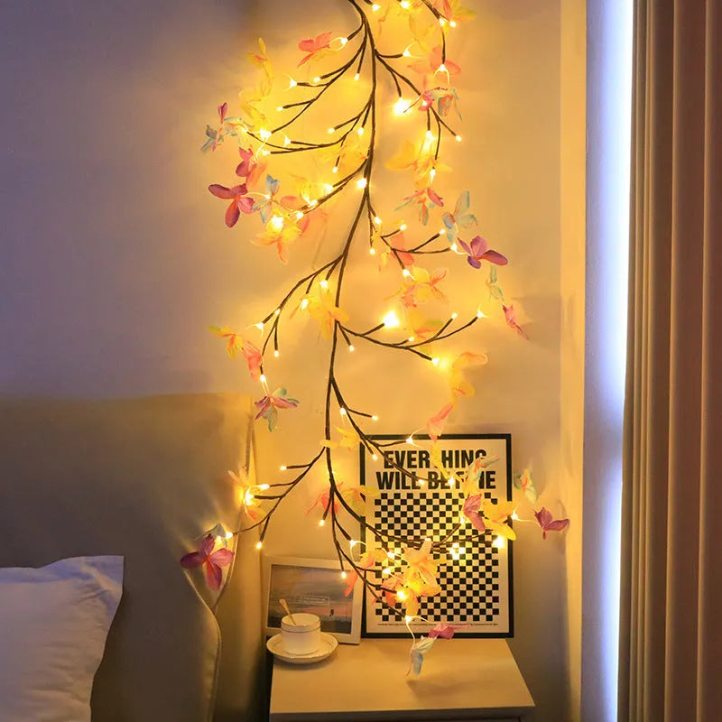 1.8 metre tall flexible rattan tree lamp with colourful LED butterflies, showing bent branches.