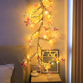 1.8 metre tall flexible rattan tree lamp with colourful LED butterflies, showing bent branches.