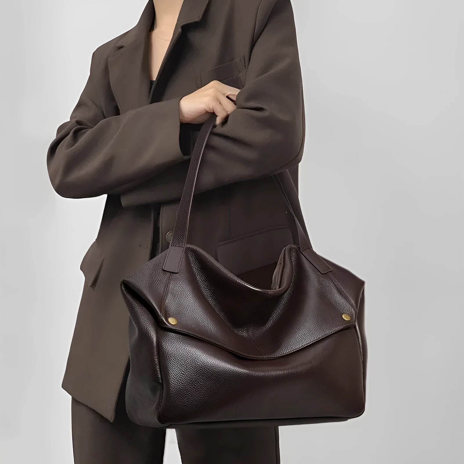 Brown genuine leather women's shoulder bag with a horizontal square shape.