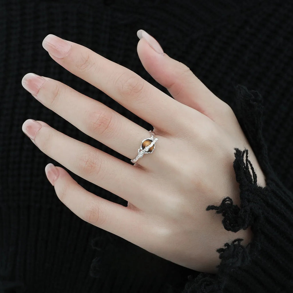 Women's adjustable Saturn open ring in electroplated white gold colour showing original design and adjustable opening mechanism