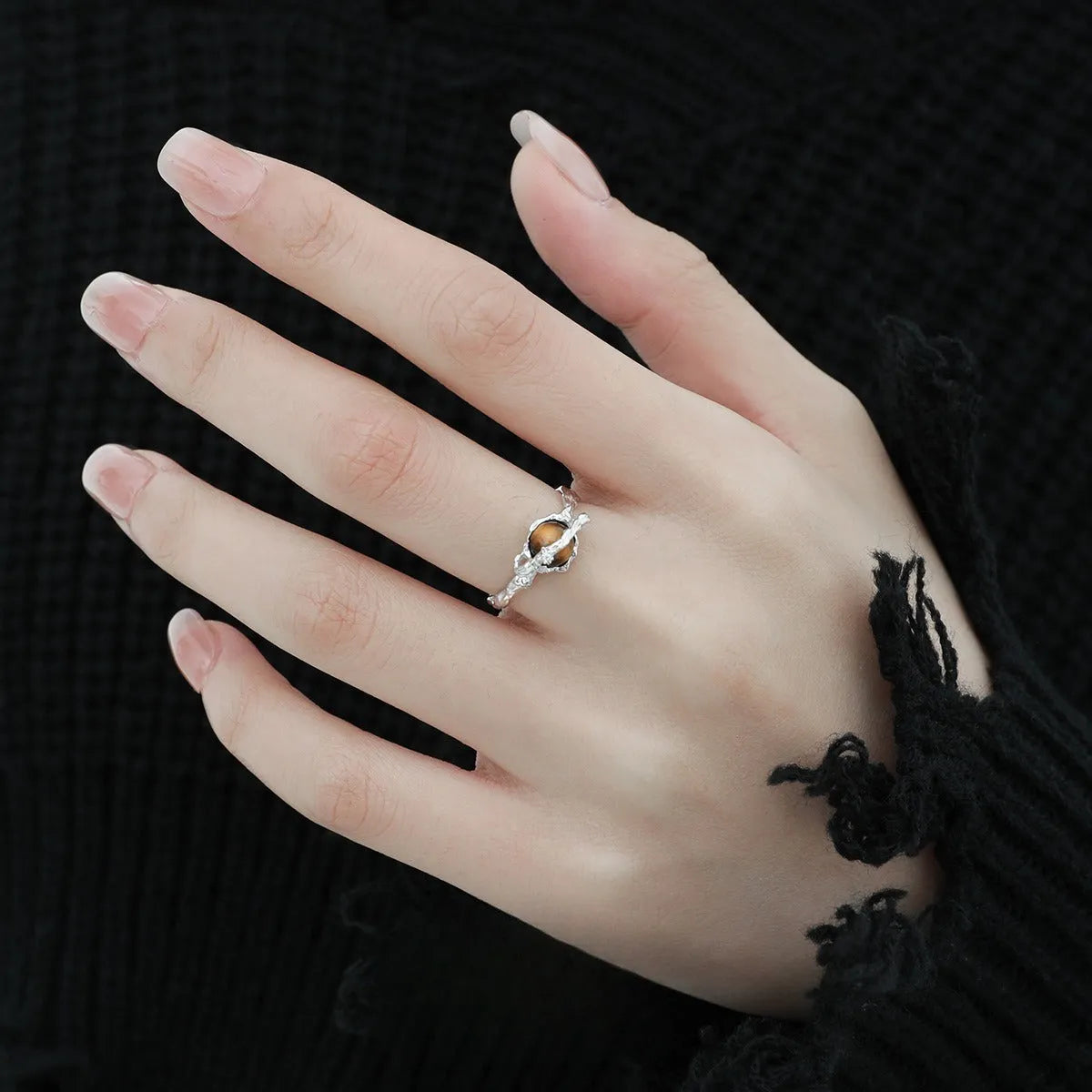 Women's adjustable Saturn open ring in electroplated white gold colour showing original design and adjustable opening mechanism