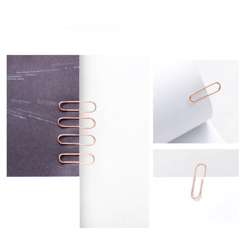 Rose gold coloured heart-shaped metal paper clips, 28mm size, in a box of 100 pieces.