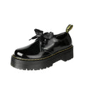 Women's black leather shoes with cross-strap design and thick TPR soles, showing ribbon detailing and lacing closure