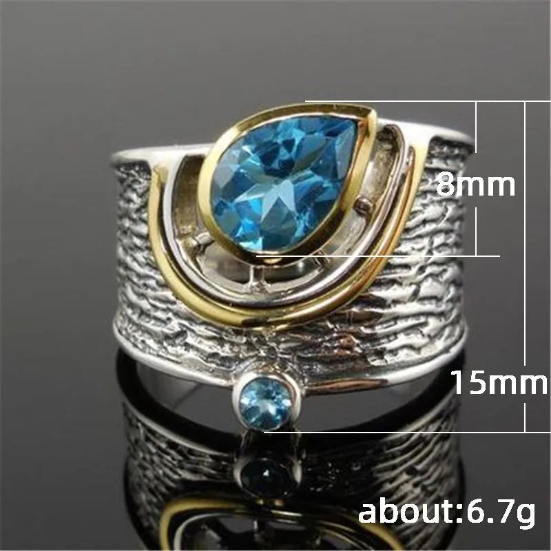 Drop-shaped blue zircon ring with inlaid stones on alloy band, showing sizes 6-10 for women's jewellery.