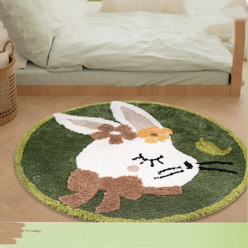 Round light pink polyester floor mat with a cute white rabbit illustration on a wooden floor.