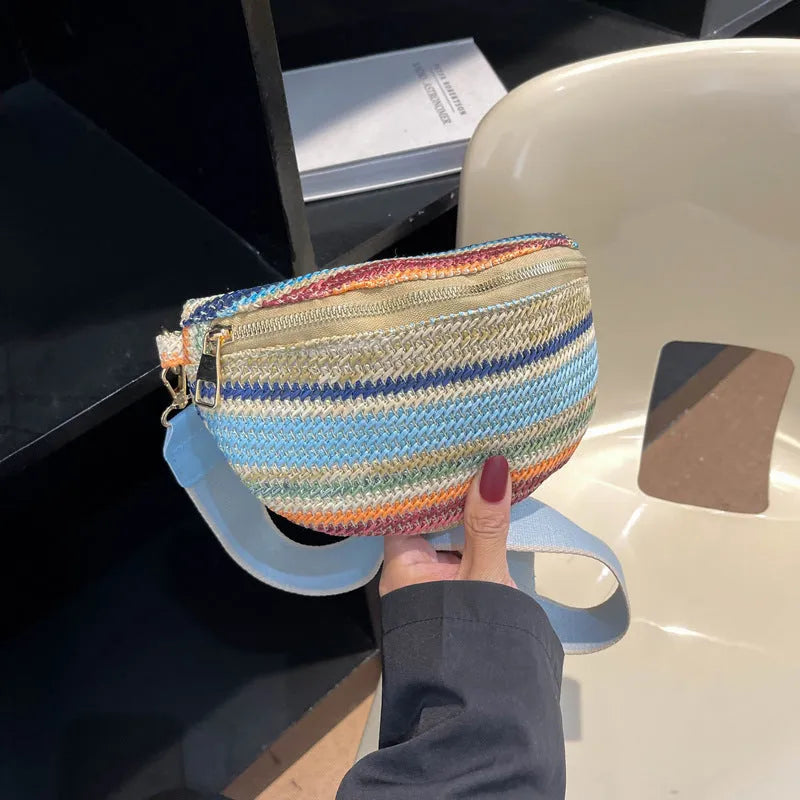 Blue straw woven women's shoulder bag with shell shape and single strap showing sandwich pocket detail