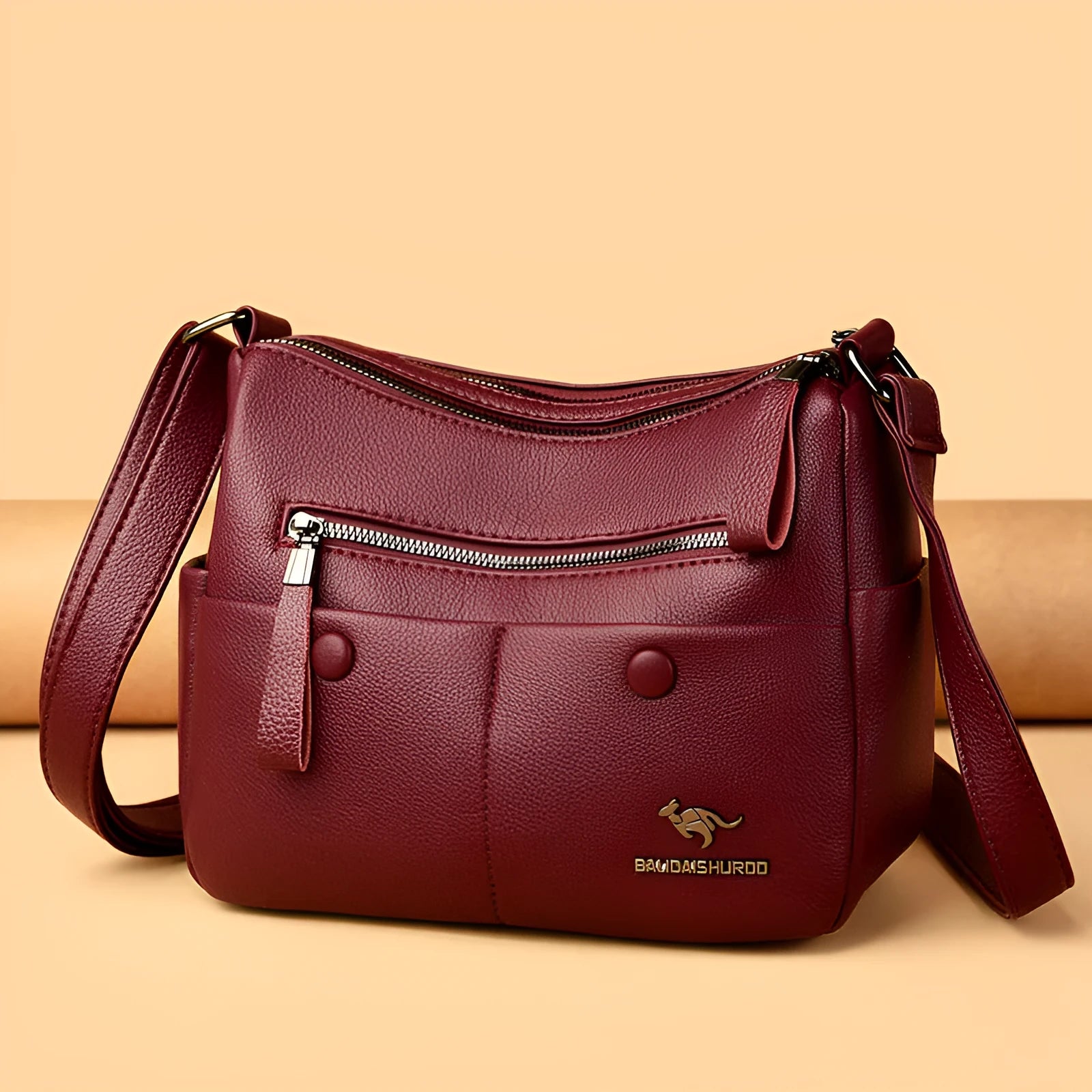 Women's soft leather crossbody bag in horizontal square shape with stitching details and crossbody strap