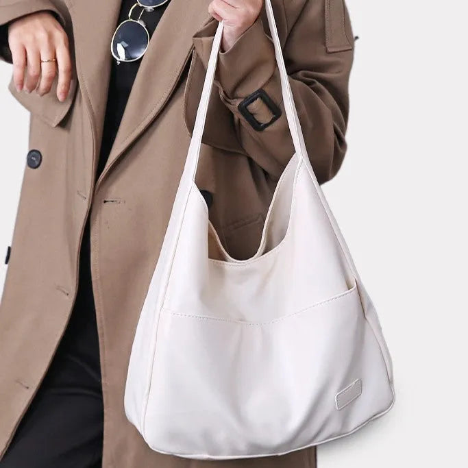 Women's soft PU leather shoulder bag in horizontal square shape showing internal zipper compartment