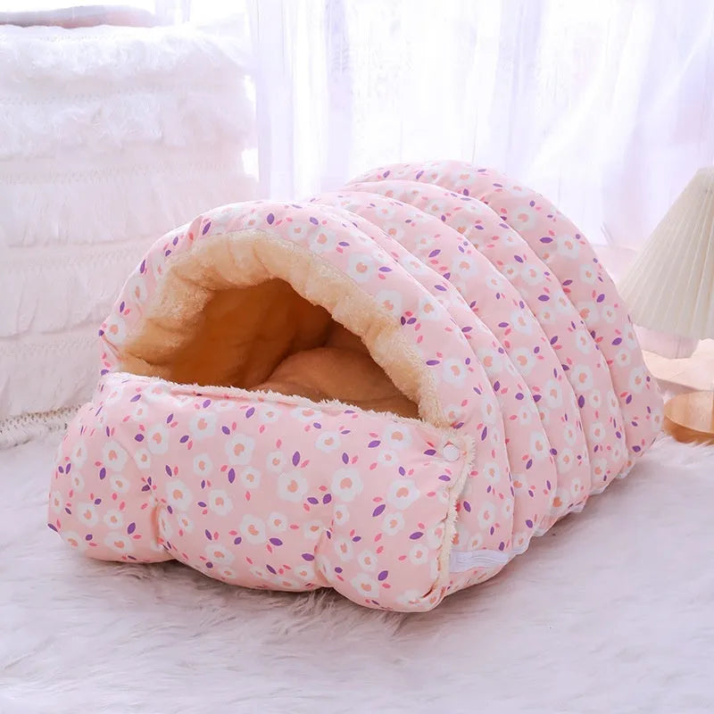 Closed cloth cat bed with removable cushion in a pink small flower pattern.