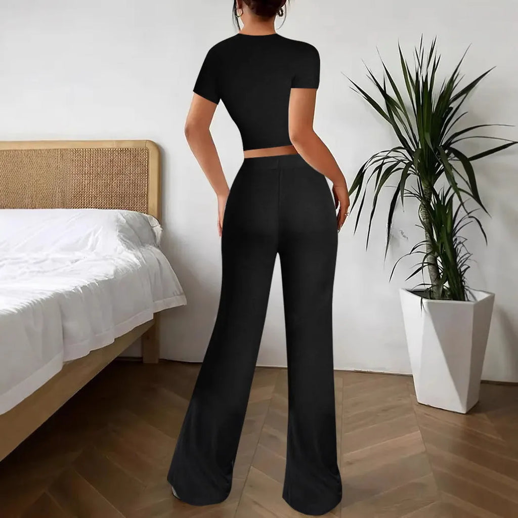 Black high waist trousers and short sleeve t-shirt suit set on a hanger