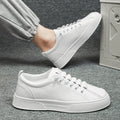 Men's low-top black and white sports casual shoes with synthetic leather upper and round toe.