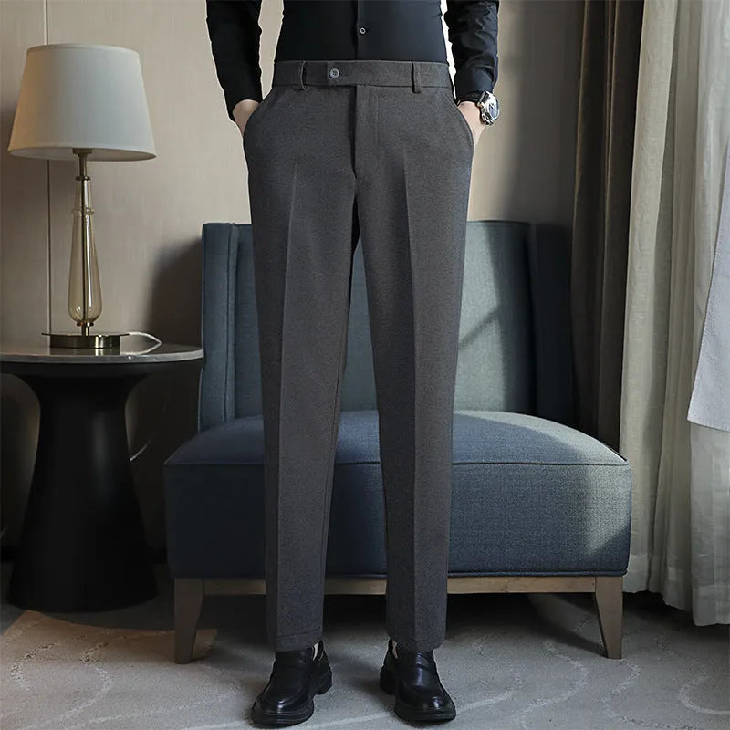 Straight leg brown corduroy trousers with an elasticated waistband on a hanger.