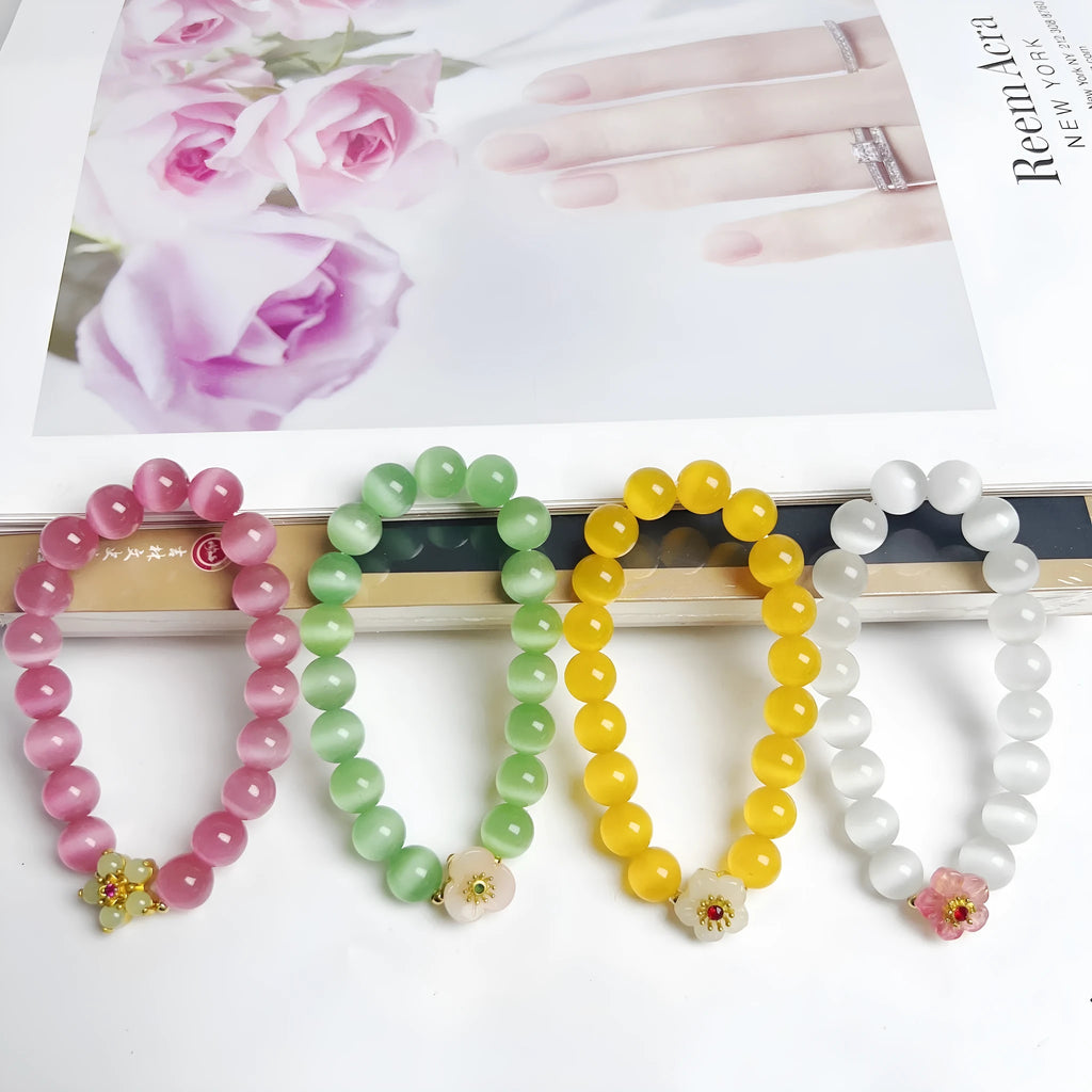 Handmade glass bead bracelet with floral designs in green, pink, white, or yellow colours
