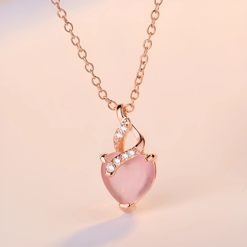 Women's heart-shaped pink crystal pendant necklace on rose gold cross chain