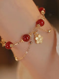Women's red agate double layer bracelet with floral motifs and adjustable sliding knot closure
