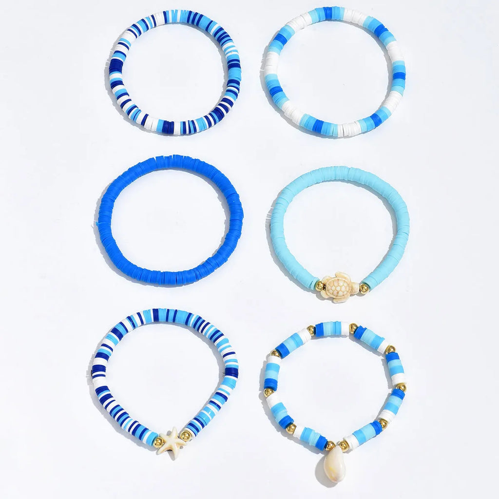 Six handmade polymer clay bracelets with geometric shapes and shell decorations in bohemian blue S3162 colour