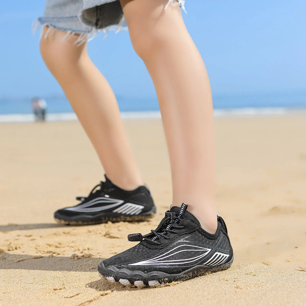 Children's black and grey quick-drying wading shoes with elastic band and rubber sole.