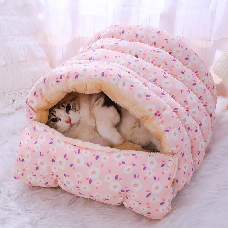 Closed cloth cat bed with removable cushion in a pink small flower pattern.