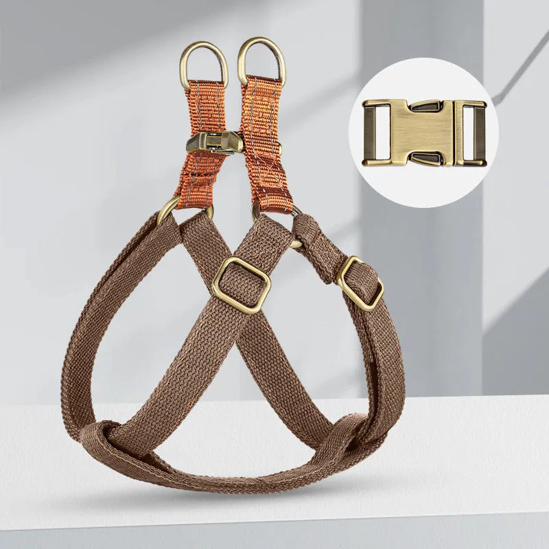 Brown vest-style dog leash worn on a person, showing the cotton belt and alloy fastener.
