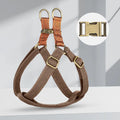 Brown vest-style dog leash worn on a person, showing the cotton belt and alloy fastener.