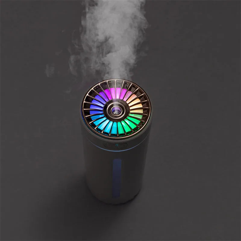 Black portable USB rechargeable humidifier with colourful LED lights on a car cup holder.