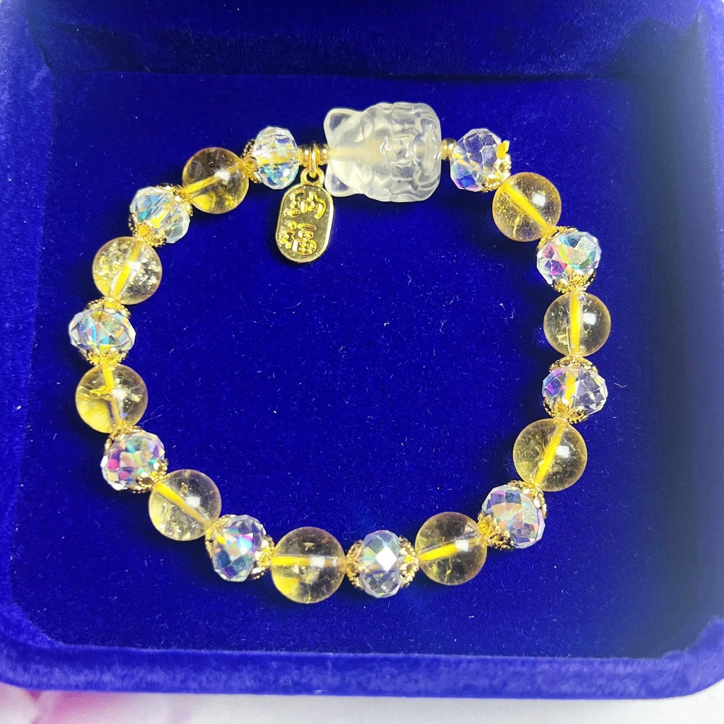 Close-up of an adjustable natural citrine crystal bracelet featuring a handcrafted nine-tail fox design on a white background.