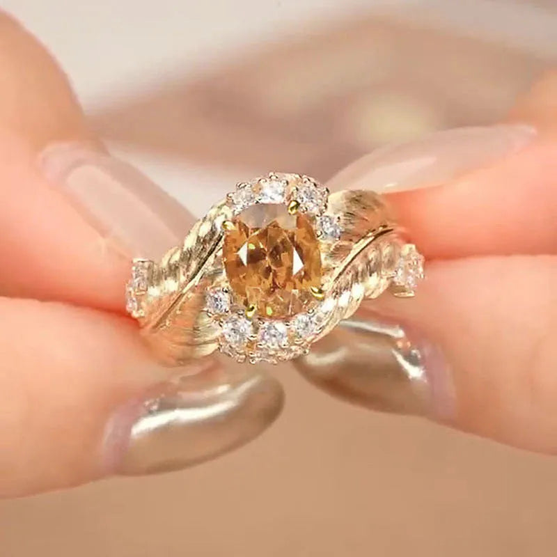 Gold-colour copper embossed feather ring with inlaid yellow zircon, shown in UK size 8
