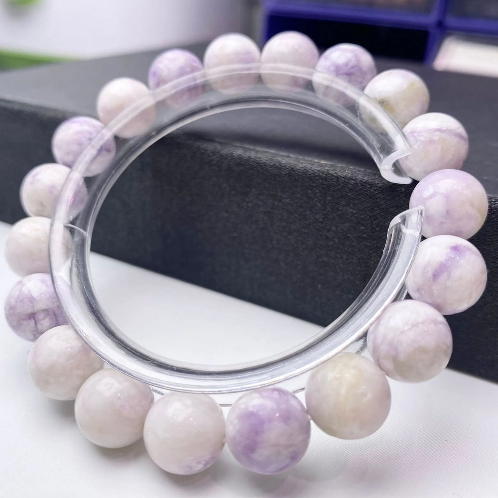 Natural purple turquoise bead bracelet for women on a white background, showing adjustable string tie.