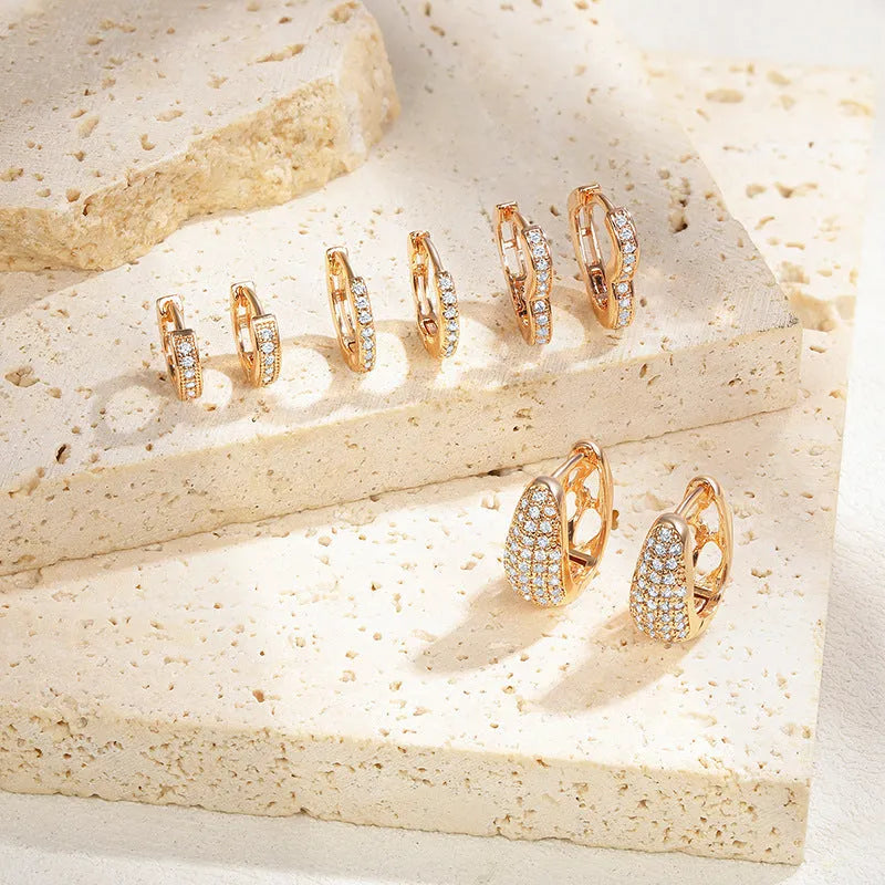 Brass gold-plated heart-shaped ear clip earrings with gang drill elements and zircon accents on copper base