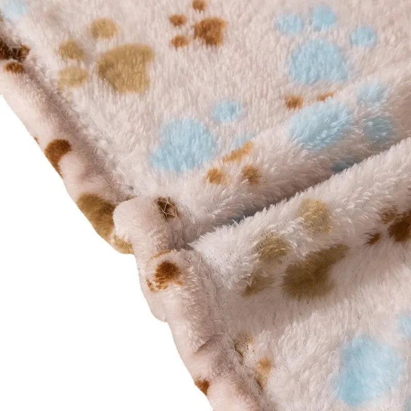 Double-sided dog blanket with cartoon patterns in blue dog, khaki paw, and blue paw designs on polyester flannel