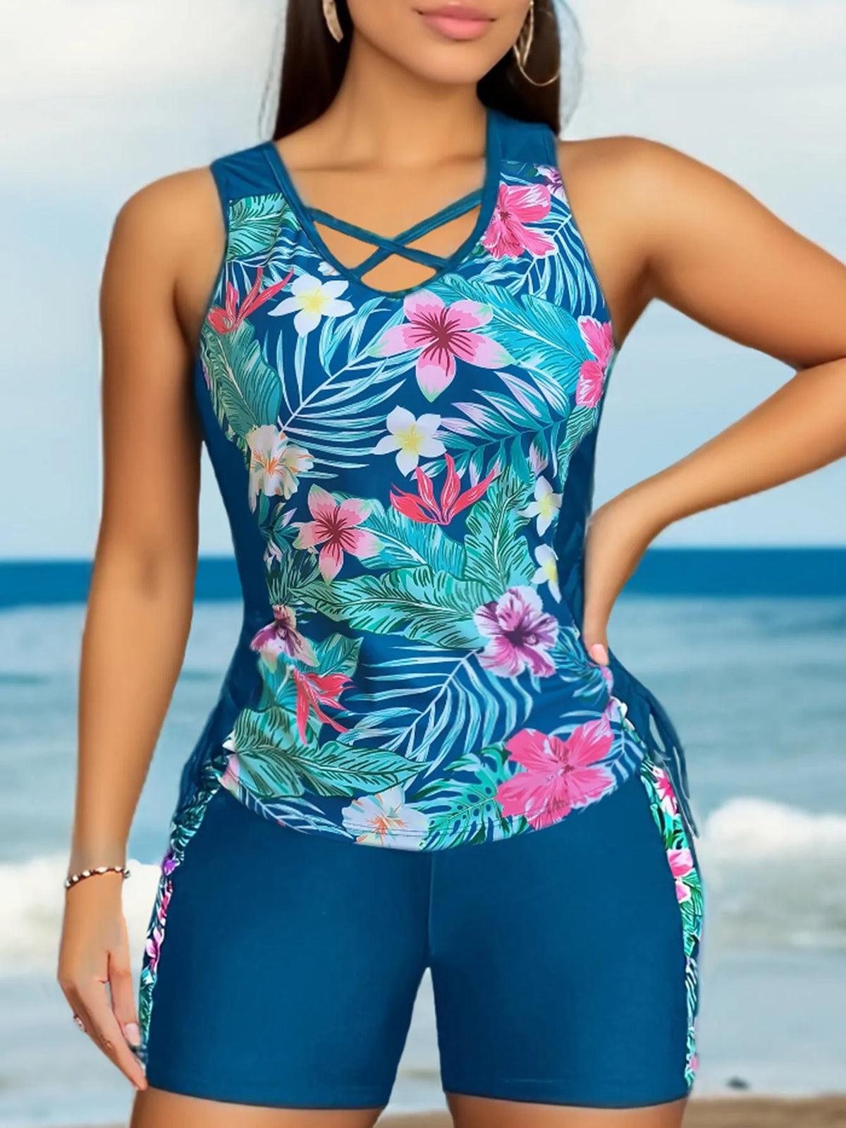 Plus-size woman modelling a high-waisted floral print bikini in blue, for swimming.