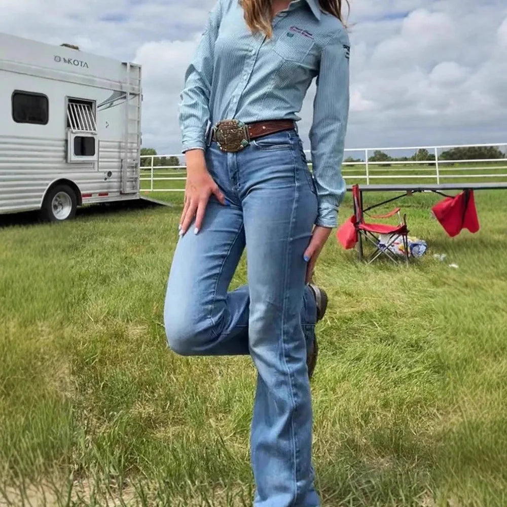Slim fit elastic mid-waist slightly flared jeans with embroidered details in blue, showing slight flare from knee to hem