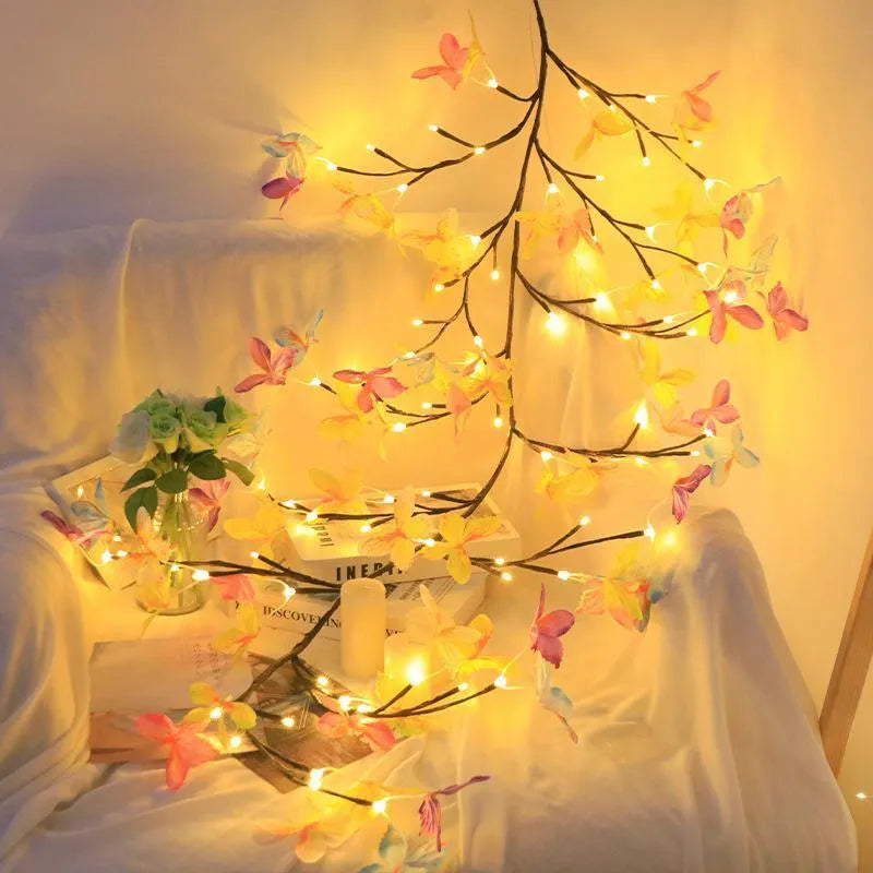 1.8 metre tall flexible rattan tree lamp with colourful LED butterflies, showing bent branches.