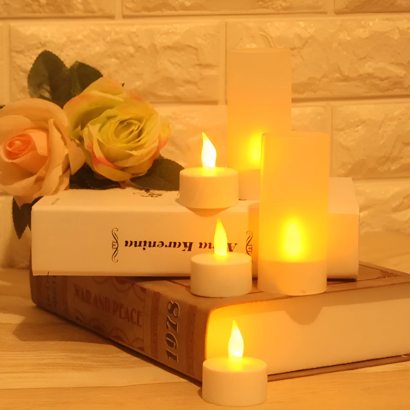 White plastic USB rechargeable LED candle lamp with flame-shaped head next to plastic cup and USB cable.