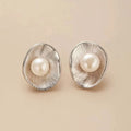 Pearl sterling silver needle earrings with geometric design and 8mm freshwater pearl centrepiece on gold background